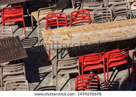 Close-up of empty restaurant tables and chairs in Liguria region, Italy, south Europe