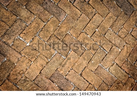 Old dirty brick stone floor texture in garden.