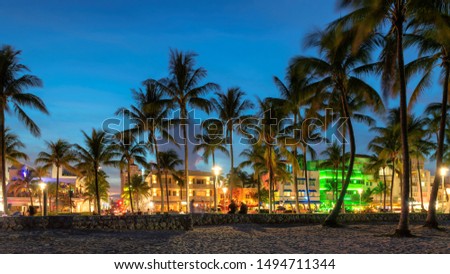 Nightlife in Miami Beach, Florida - hotels and restaurants at sunset on Ocean Drive, world famous destination.