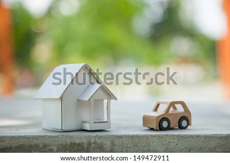Home and car artificial on the concrete. Royalty-Free Stock Photo #149472911