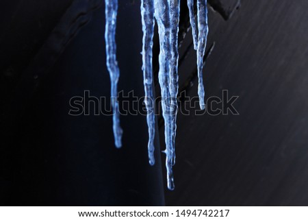 Hanging icicles grouped in winter Royalty-Free Stock Photo #1494742217