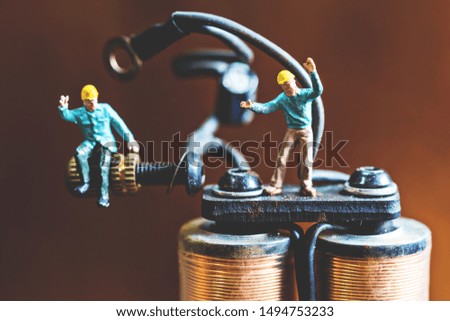 selective focus of miniature worker in work shop tool ,macro photography. miniature worker concept.