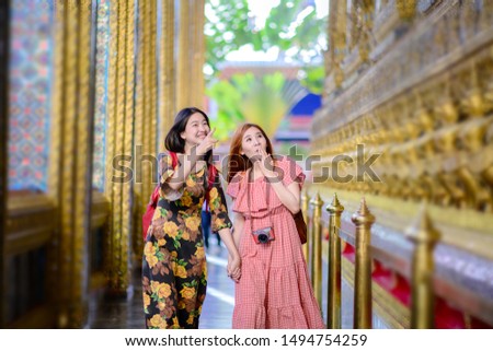 young tourist women walking in walk pathway of the palace temple in Bangkok of Thailand, Emerald Buddha Temple, Wat Phra Kaew, Bangkok Royal Palace popular tourist place
