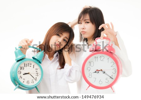 Asian woman holding an alarm clock in the  morning