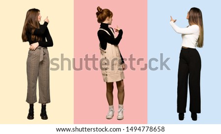 Set of women pointing back with the index finger