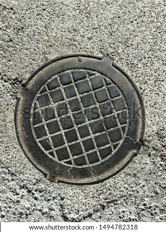 metal cover and gray asphalt image