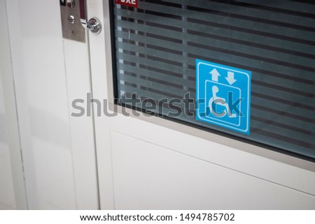 The International Symbol of Access (ISA), also known as the International Wheelchair Symbol, on elevator door.