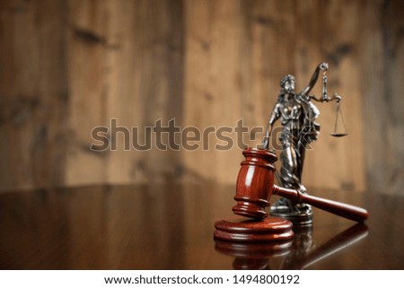Judge's gavel, scales of justice, on vintage wooden table. Law concept.