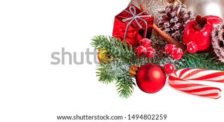 Christmas Card with a red ornament, golden balls, berries, fir tree, snow  and pine cones isolated on white background.  Winter holiday concept
