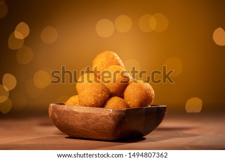 Indian sweet laddu with decorated festive light background. Royalty-Free Stock Photo #1494807362