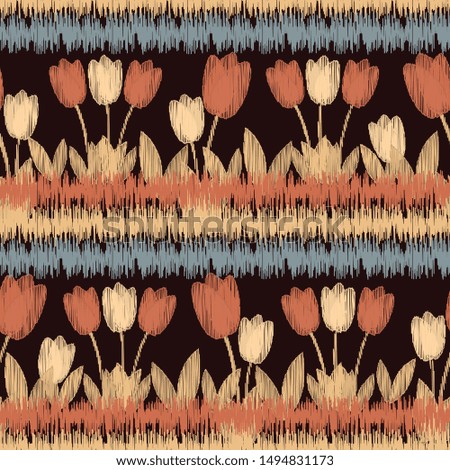 Seamless ikat pattern with the image of flowers.
