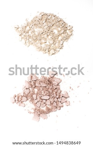 Top view of cracked pink and silver compact highlighting powders