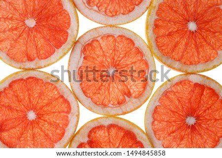 Grapefruit slices background. Close-up Grapefruit slices abstract background. Bright summer texture.