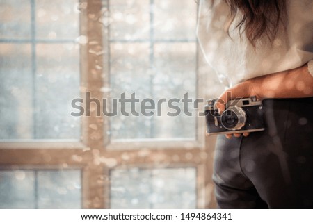 Close up of vintage camera in hand of hipster woman 