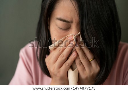 Asian woman got nose allergy, flu sneezing nose. Royalty-Free Stock Photo #1494879173