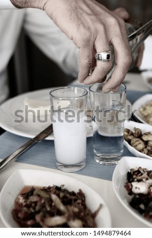 Turkish and Greek Traditional Dinning Table with Special Alcohol Drink Raki. Ouzo and Turkish Raki is a dry anise flavoured aperitif that is widely consumed in Turkey, Greece, Cyprus and Lebanon
