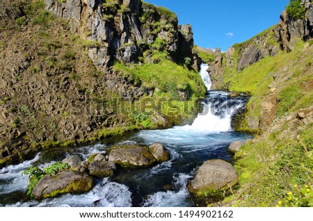 Summer Icelandic waterfull in rocks