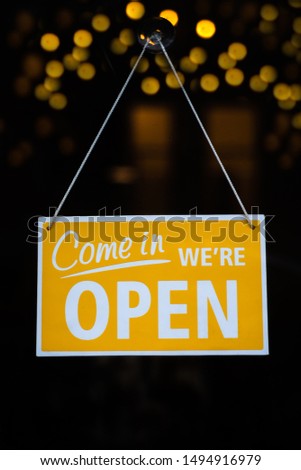 Open Sign on Glass Window With Bokeh Lights in the Background