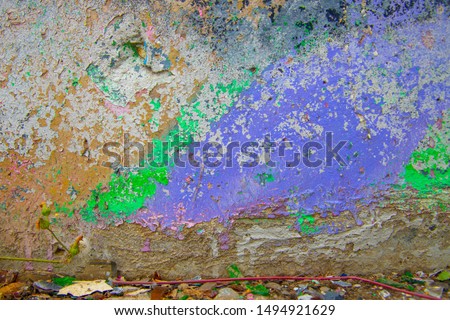 Abstract background. Closeup fragment of cracked and peeling painted wall.
