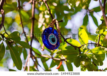 Multicolored nazar - evil eye amulets in store on the street. Close-up, shallow depth of field. Picture with bokeh and Sun ray