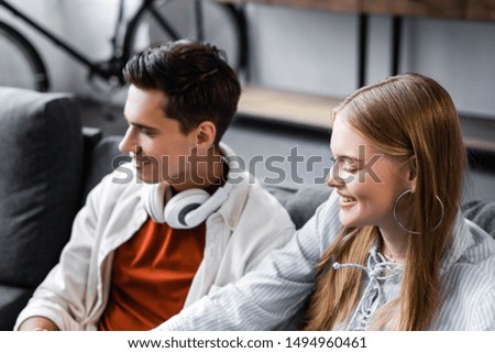 handsome and attractive friends with closed eyes smiling in apartment 