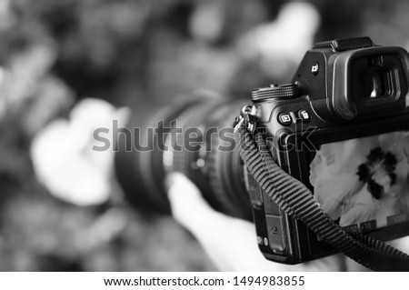 Taking pictures, macro photography, focus on the camera - black and white image 