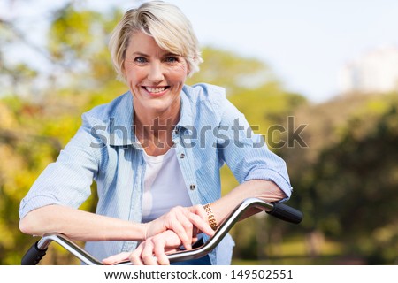 close up portrait of senior woman on a bicycle Royalty-Free Stock Photo #149502551
