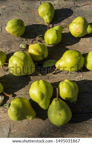 locally grown green California pears on rustic outdoor tabletop