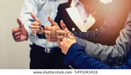The business group thumbs up to show appreciation and is happy to praise the achievements of collaborators. Royalty-Free Stock Photo #1495043426