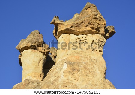 Beautiful fungous forms of sandstone in the canyon. Magic Cappadocia, near Cavusin village, Nevsehir Province in the Central Anatolia Region of Turkey, Asia. Beauty of nature. Concept background
