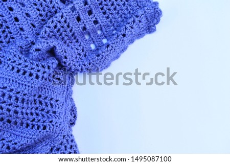 white background with blue warm handmade knitted plaid