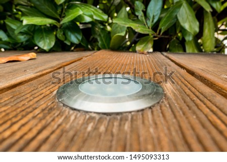 Installation of LED spotlights in a wooden terrace in the garden Royalty-Free Stock Photo #1495093313