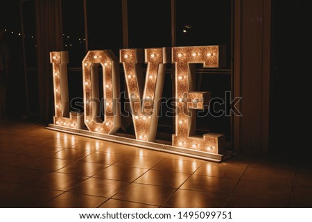 Giant gold Love Letters lit up