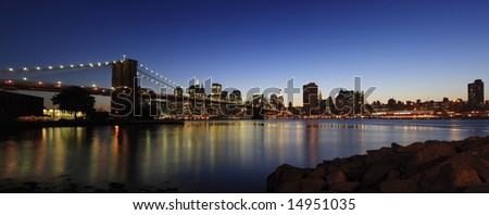 Panoramic view of Brooklyn Bridge and Manhattan skyline at dusk - New York City, USA (high-res panoramic shot stitched from 5 pictures)