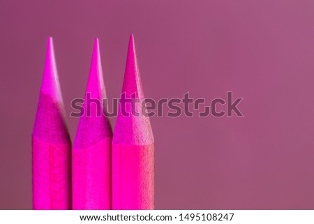 Colored pencils close-up in a trendy neon light. The concept of artistic accessories, creativity. Place for text, minimalism.