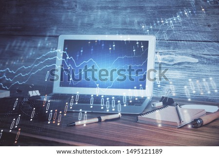 Financial chart drawing and table with computer on background. Multi exposure. Concept of international markets.