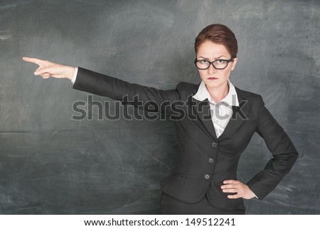 Angry teacher in glasses pointing out Royalty-Free Stock Photo #149512241