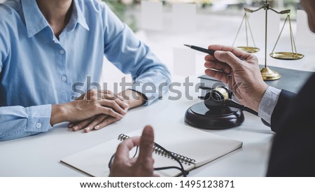 Consultation and conference of Male lawyers and professional businesswoman working and discussion having at law firm in office. Concepts of law, Judge gavel with scales of justice. Royalty-Free Stock Photo #1495123871
