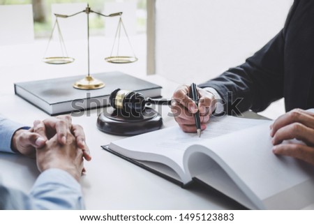 Consultation and conference of Male lawyers and professional businesswoman working and discussion having at law firm in office. Concepts of law, Judge gavel with scales of justice. Royalty-Free Stock Photo #1495123883