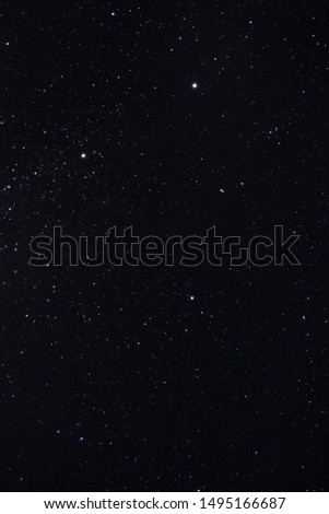 Stars in the night sky through the clouds