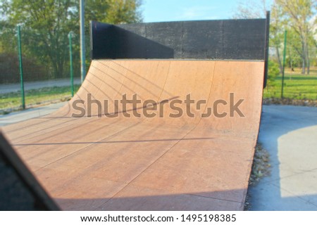 Public skateboard park with various paths and ramps with natural green background