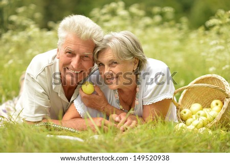 loving elderly couple having a picnic in the summer