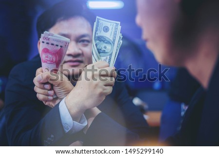 Businessman holding Dollars and Yuan money Competing In Arm Wrestling. Trade war concept