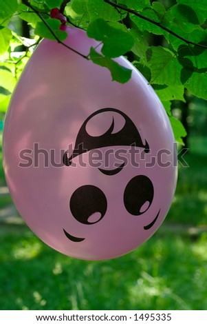 balloon with funny picture on tree