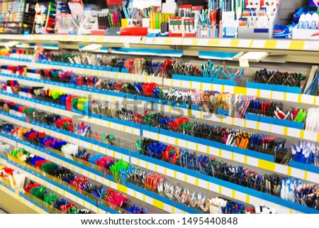 Image of shelves with a different pens and stationery in a stationery shop 