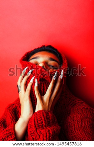 young pretty indian girl in red sweater posing emotional, fashion hipster teenage, lifestyle people concept close up