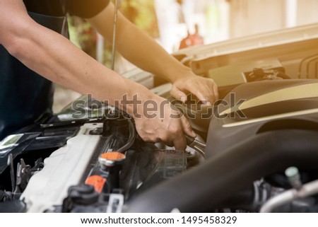 Auto mechanic working in garage. Repair service. Royalty-Free Stock Photo #1495458329