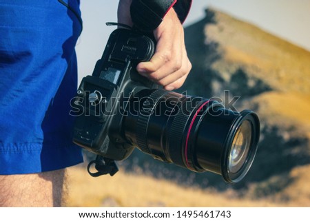 young photographer holds a camera