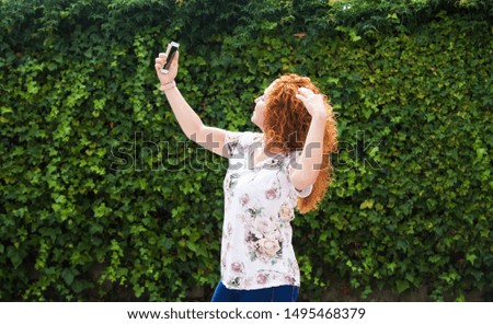 woman taking a selfie with the mobile phone