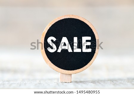Sign board sale lettering on blurry background 